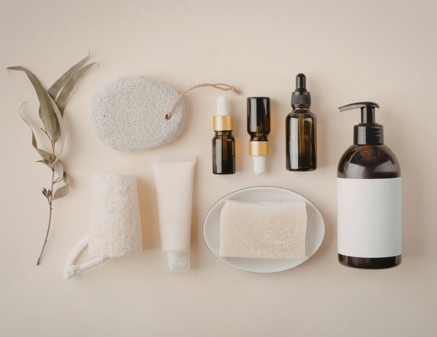 Natural low tox pregnancy skincare products including oils, serums and body wash on neutral background
