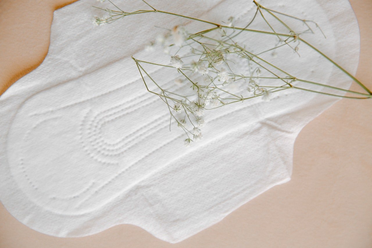 Postpartum sanitary pad with flowers, symbolising healing and recovery after childbirth