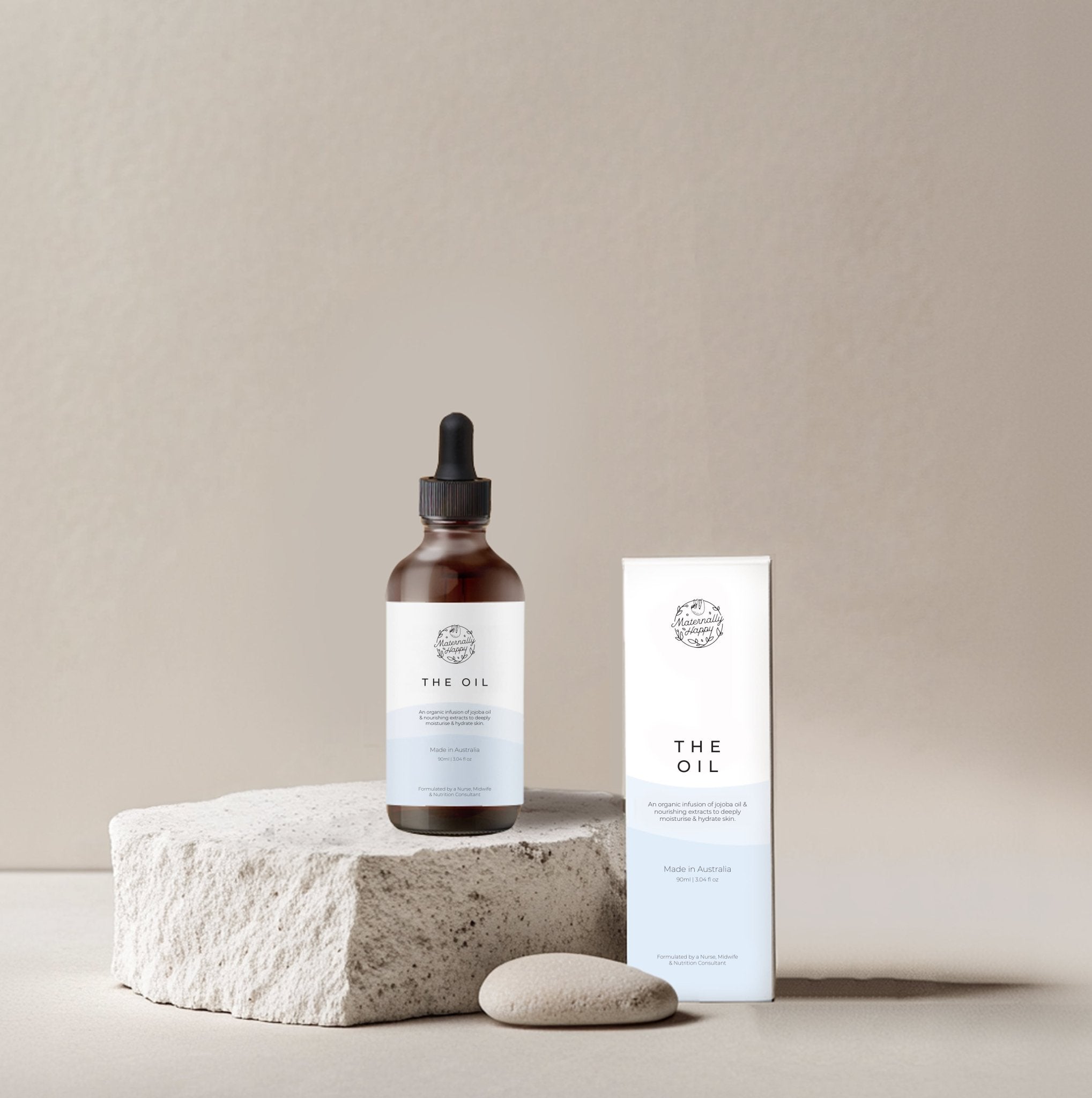 Organic baby oil and pregnancy safe skincare – The Oil bottle and box on stone background