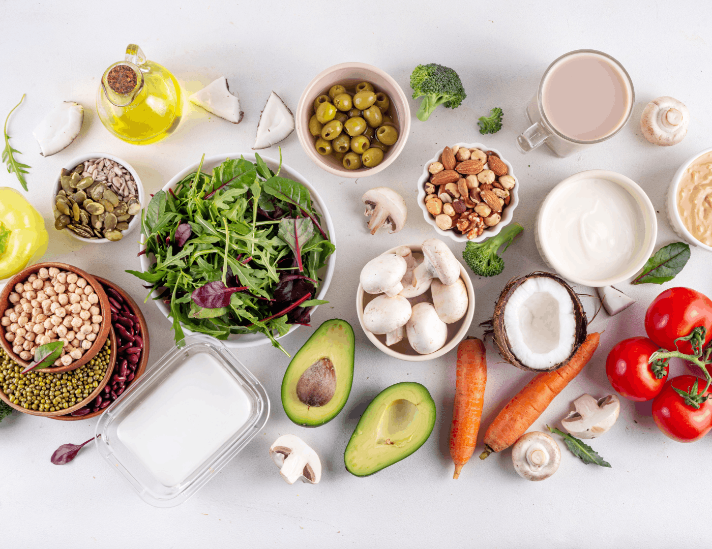 Variety of plant-based foods including legumes, vegetables, nuts and seeds for vegan pregnancy nutrition